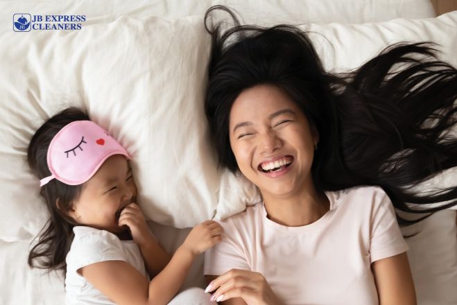 Neatly folded linen blankets tied with cotton on wooden crate, minimal style.